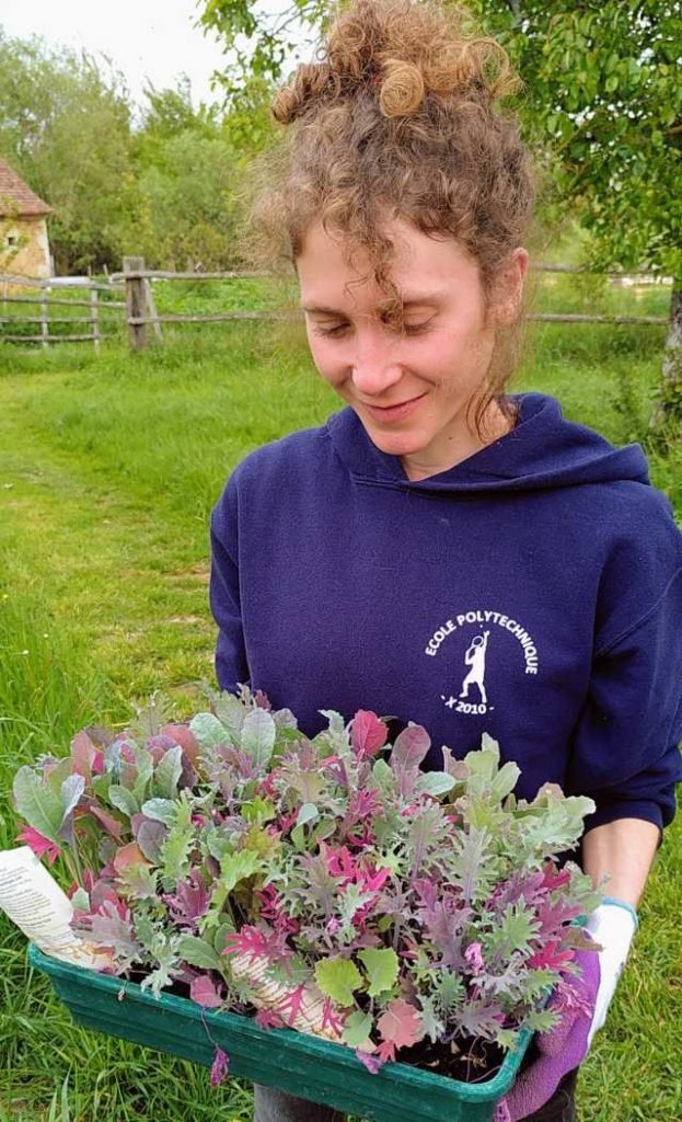 Helen holding a tray of kale